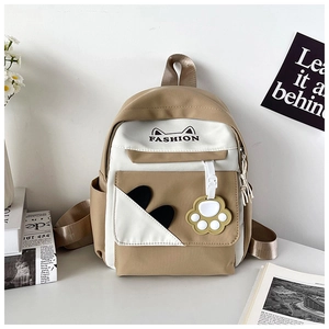 Close-up of contrast color backpack with cute cat paw charm and fashion text print