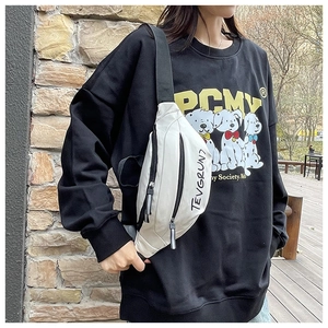 Detail of white canvas crossbody saddle bag featuring black double zippers and logo