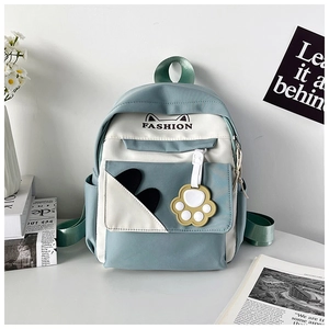 Detail of blue and white backpack with cute cat paw charm and fashion embroidery