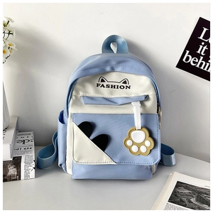 Detail of blue and white backpack with cat ear patterns and a cute paw pendant charm