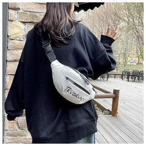 Detail of white nylon crossbody bag featuring black letter print and adjustable buckle strap