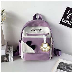 Close-up of purple and white school backpack with cute cat paw pendant and side pockets