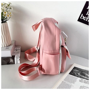 Side view of a pink and white high-capacity school backpack with a side pocket and strap