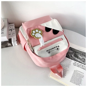 Detail of pink and white cat-themed backpack with cute paw charm and fashion text