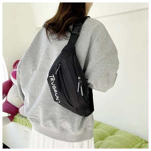 Close-up of black crossbody bag with white letter print and durable zipper detail