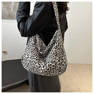 Detail of large leopard print canvas hobo bag showing spacious design and wide strap