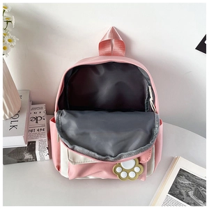 Detail view of the spacious inner compartment of this pink and white school backpack