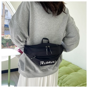 Detail of black nylon crossbody bag with TEVGRUN1 lettering and adjustable strap
