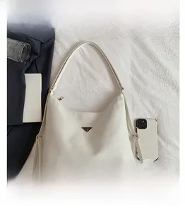 Macro shot of white large tote bag featuring lychee grain texture and metal triangle logo