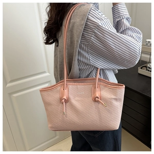Détail du sac cabas rose avec texture plissée et décoration de logo à la mode