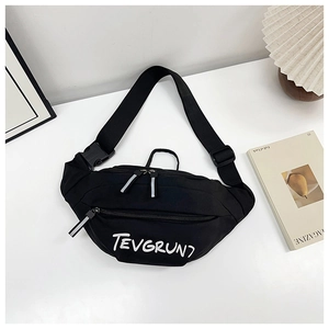 Detailed shot of black crossbody bag with TEVGRUNT lettering and adjustable strap