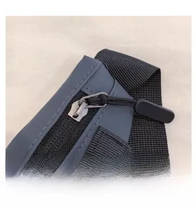 Détail de la fermeture éclair en métal lisse avec tirette antidérapante sur sac gris