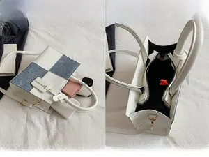 Detail view of the interior compartment and daily essentials in a contrast handbag