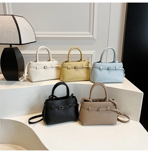 Litchi pattern leather bucket bags in five colors displayed on minimalist pedestals