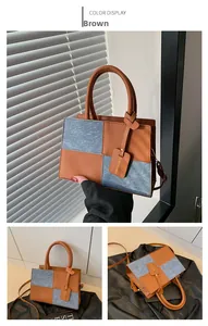 Detail of color block handbag showing brown leather and grey suede patchwork texture