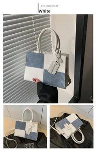 Detail of blue and white patchwork handbag with fashion tag and textured material