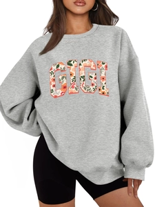 Détail du sweat Gigi gris avec imprimé floral et coupe surdimensionnée décontractée