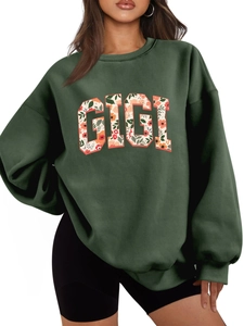 Gros plan sur l'imprimé floral GIGI d'un sweat-shirt à col rond vert foncé pour femme