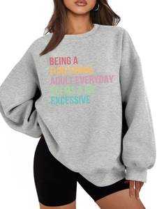 Detail of light grey sweatshirt featuring colorful gradient text and soft fleece texture