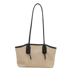 Beige woven tote bag with black leather trim and long shoulder straps on white background