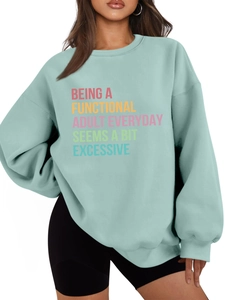 Detailed view of Being a Functional Adult slogan on a mint green casual sweatshirt