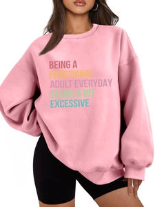 Detail of pink oversized sweatshirt with colorful slogan print for a casual style