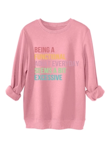 Close-up of pink casual sweatshirt showing rib-knit cuffs and slogan print detail
