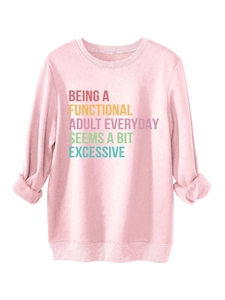 Detailed view of pink casual sweatshirt featuring colorful slogan print and ribbed cuffs