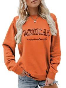 Detail of orange crewneck sweatshirt with Medical Assistant print and ribbed cuffs