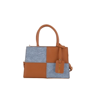 Chic patchwork square handbag in brown leather and blue fabric with a fashion tag