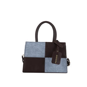 Contrast color patchwork tote bag with checkered tweed texture and dark leather handles