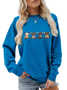 Detail of four cartoon highland cows print on a blue round neck sweatshirt for women