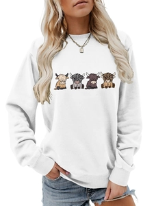Close-up of white crewneck sweatshirt with four colorful highland cow cartoon prints