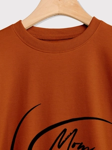 Detail of rust red mom basketball sweatshirt with ribbed neckline and fine knit texture