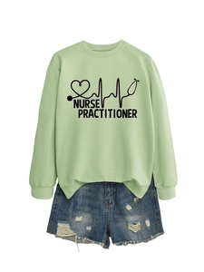 Flat lay of light green Nurse Practitioner sweatshirt with denim shorts on white background