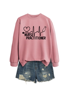 Flat lay of pink nurse practitioner sweatshirt with distressed denim shorts