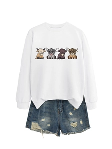 White crewneck sweatshirt with cute cartoon highland cow prints and distressed denim shorts