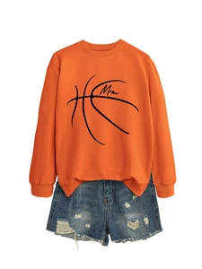 Detail of orange mom basketball sweatshirt and ripped denim shorts on white background