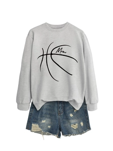 Close-up of Mom basketball print on casual grey long-sleeve sweatshirt with denim shorts