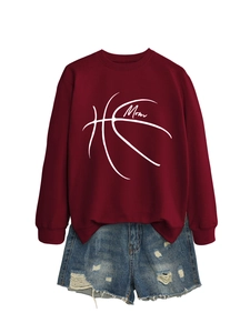 Detailed view of burgundy sweatshirt with basketball Mom print and ripped denim shorts