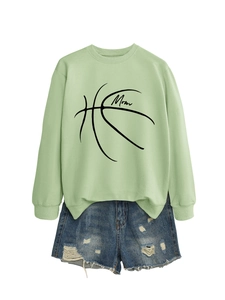 Flat lay of light green Mom basketball sweatshirt and distressed blue denim shorts