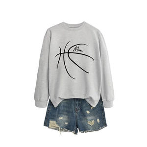 Gray mom basketball sweatshirt paired with distressed blue denim shorts on white background