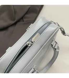 Detail showing smooth silver metal zipper on light blue textured leather Boston bag