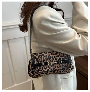 Detail of vintage baguette bag featuring leopard print and gold horsebit buckle