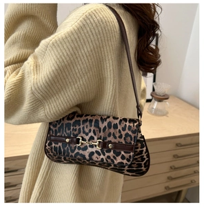 Detail of vintage leopard print underarm bag featuring a gold horsebit buckle on the flap