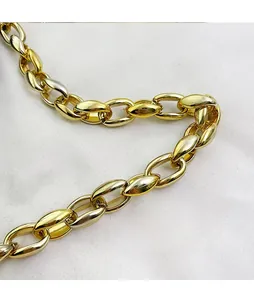 Detailed close-up of a polished gold metal chain strap for a crossbody shoulder bag