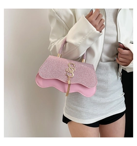 Pink sequined handbag with wavy edge detail and gold S-shaped buckle with fringe