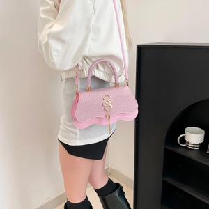 Pink glitter crossbody bag with wave edge design and golden S-logo metal tassel