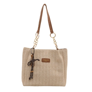 Minimalist woven straw tote bag with gold chain leather handles for beach vacation fashion