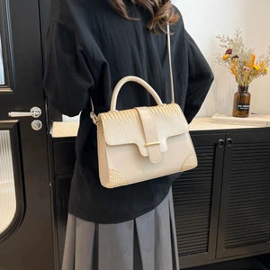 Chic beige crossbody bag with crocodile embossed flap and metallic buckle closure